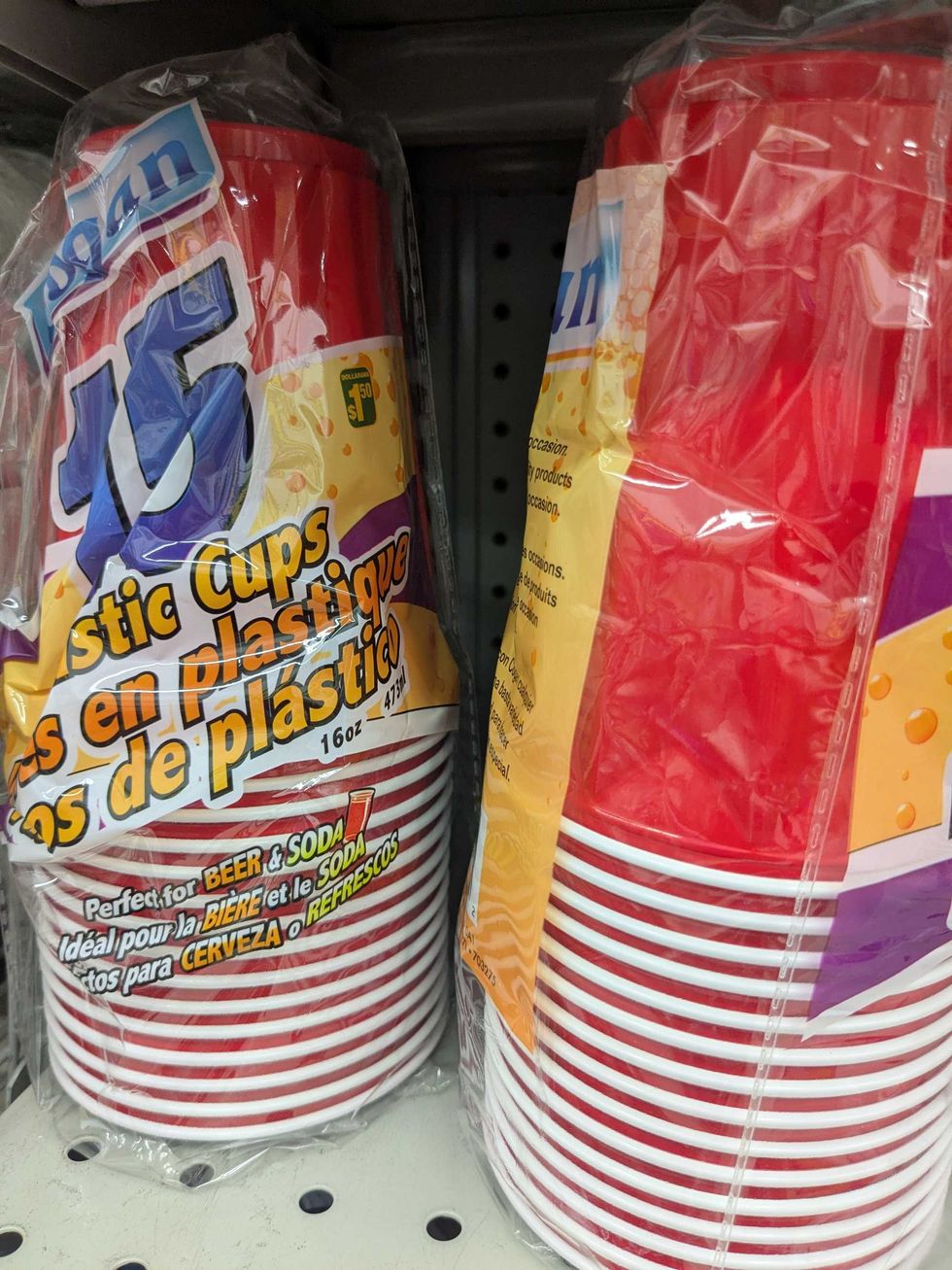Red plastic cups on a shelf at Dollarama