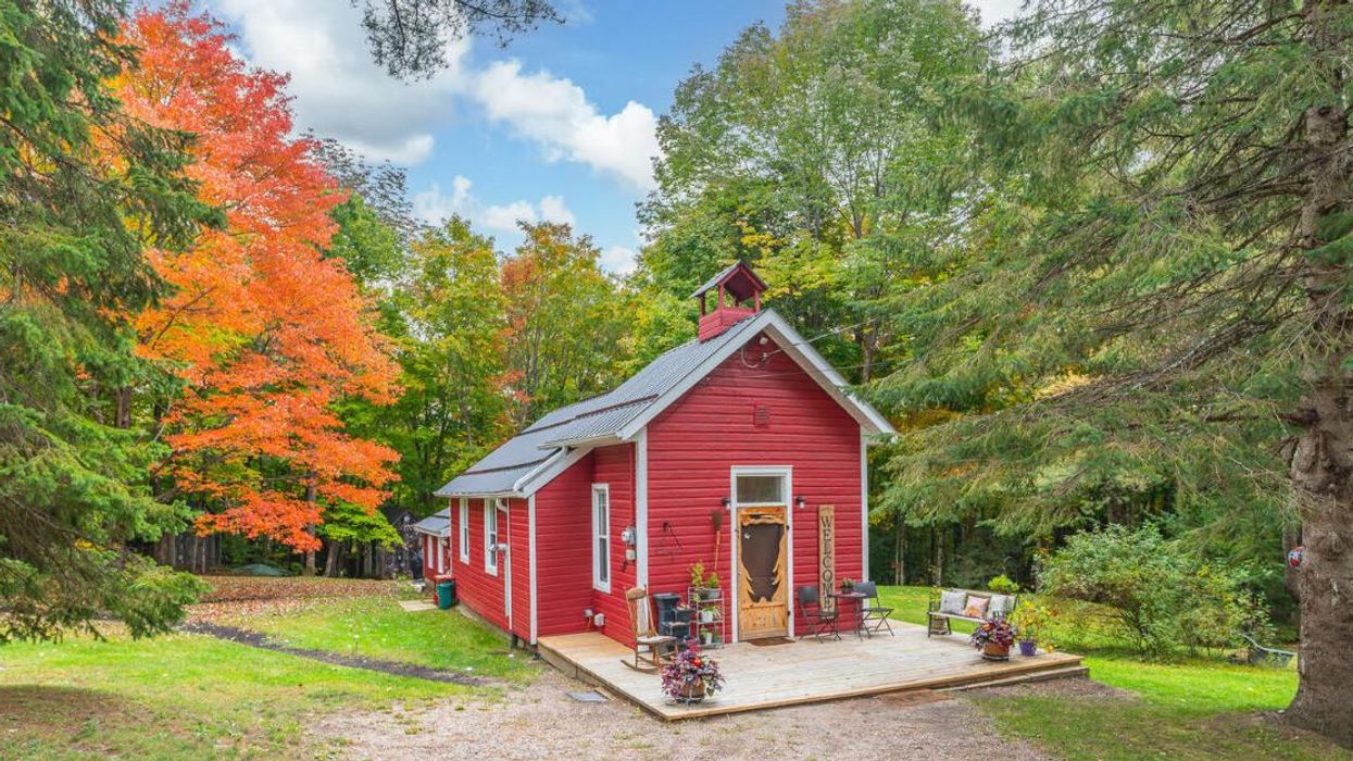 Red schoolhouse home for sale.