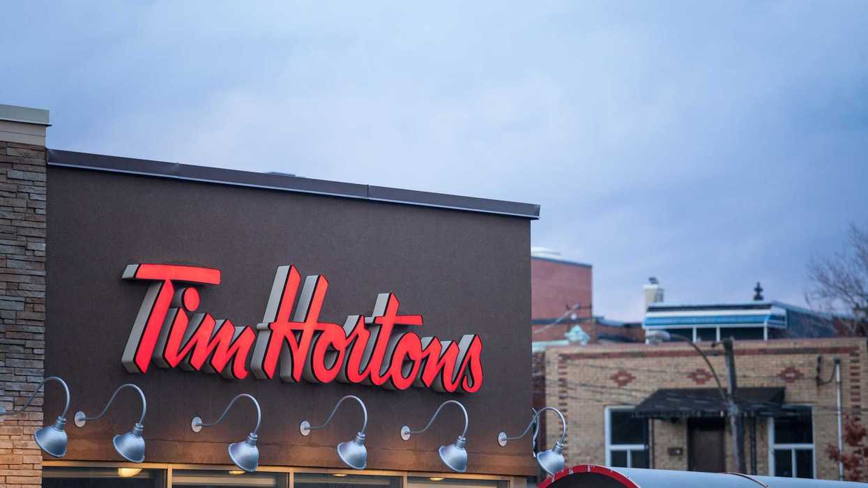 red tim hortons sign on exterior of restaurant location in canada