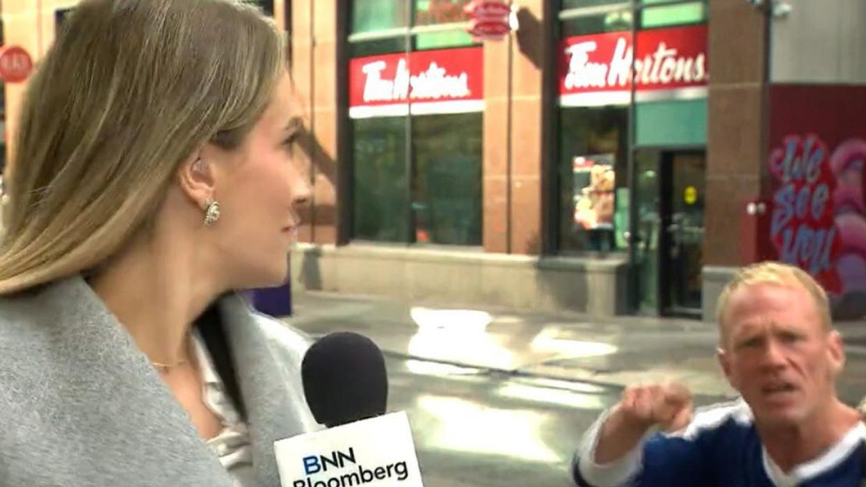 Reporter reacts to heckler on live TV.