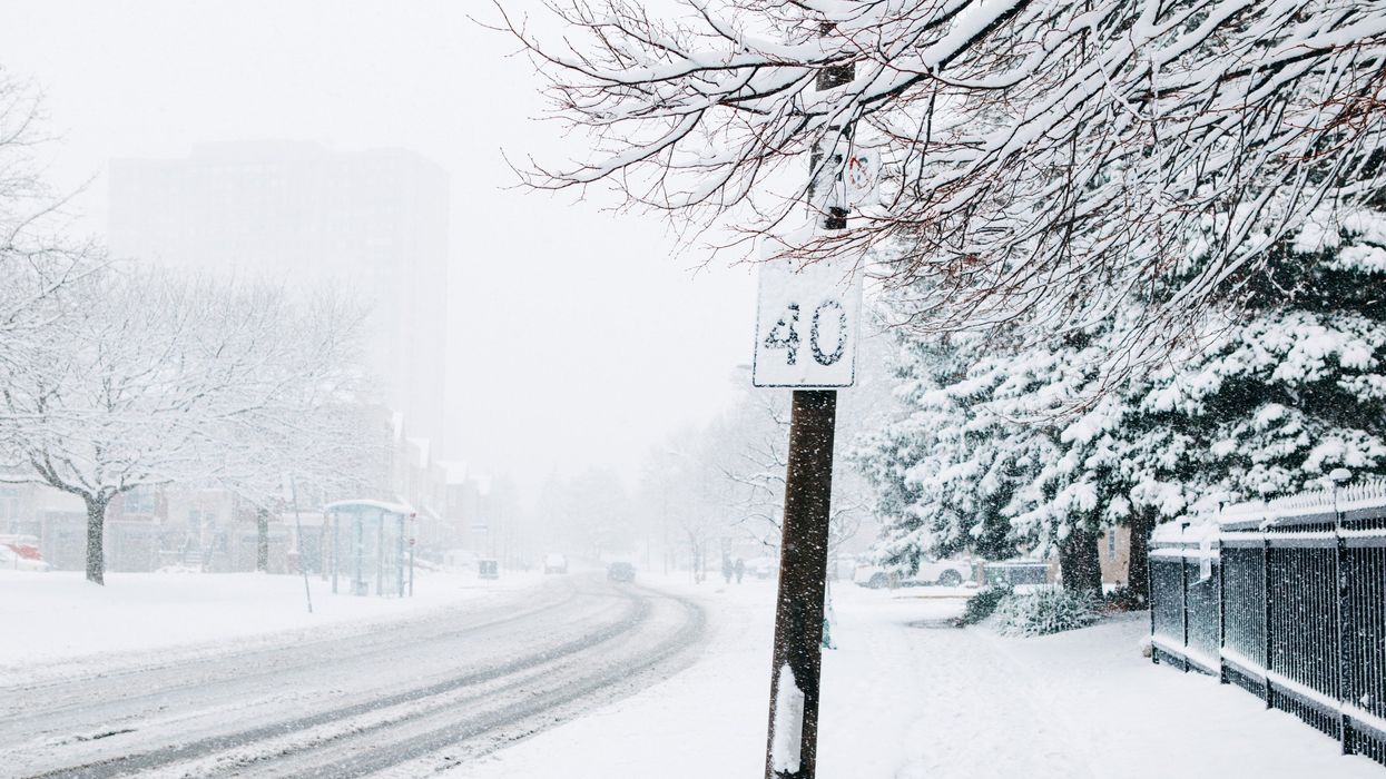 road in ontario covered in snow during a snowstorm