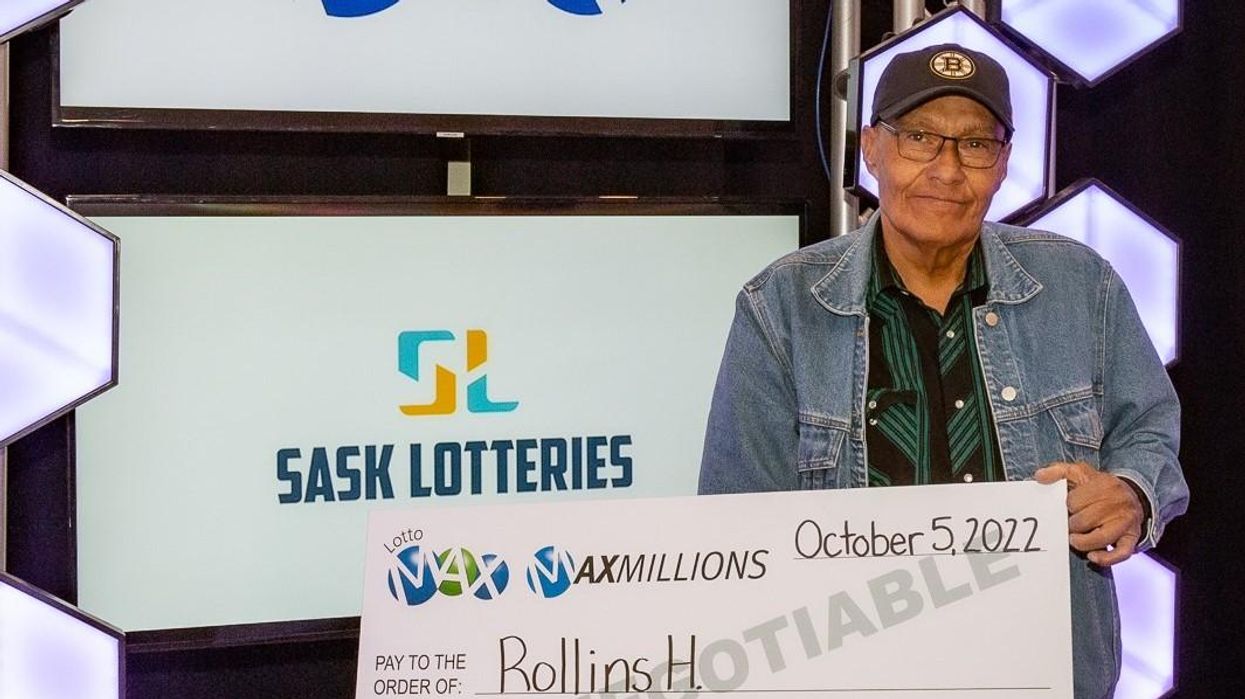 Rollins Head holds up a cheque.