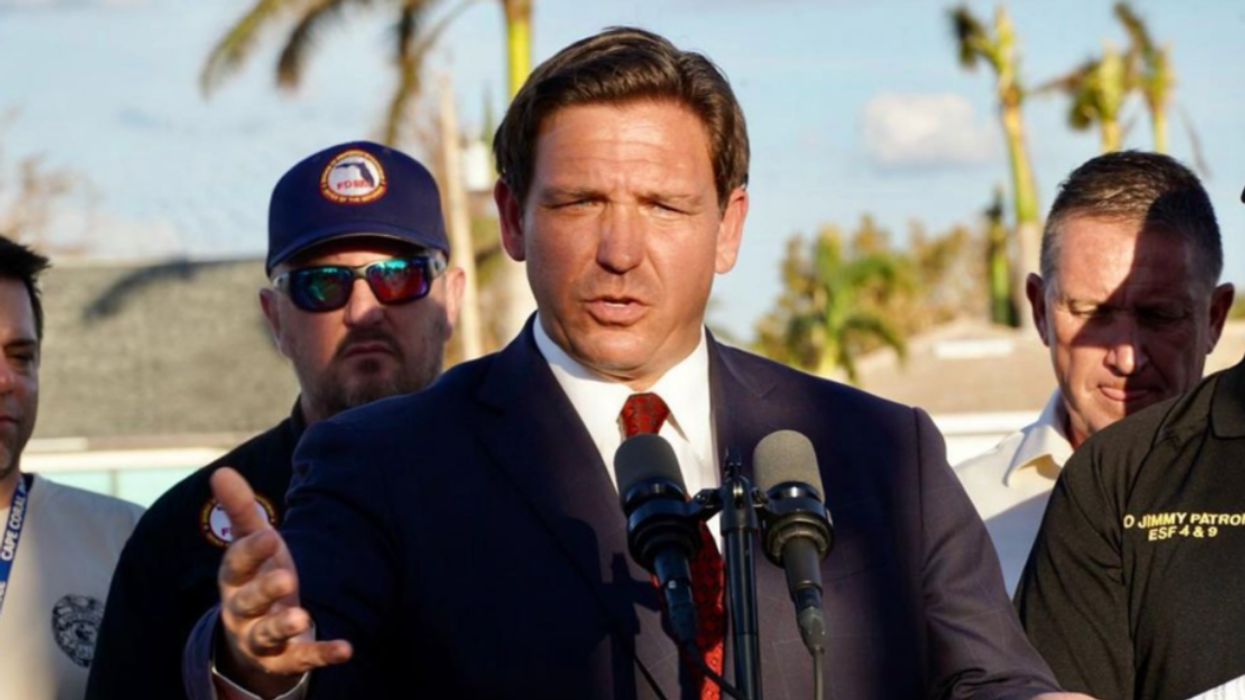 Ron DeSantis at a podium.
