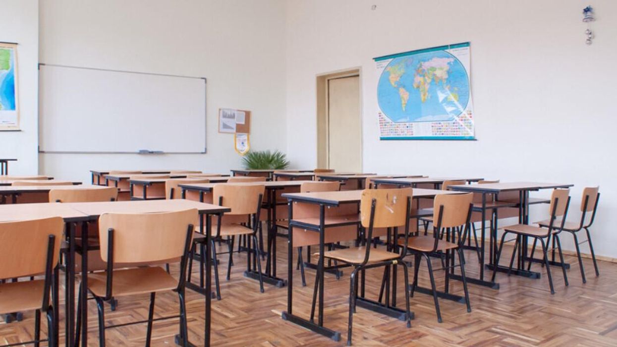 Rows of desks in an empty classroom.