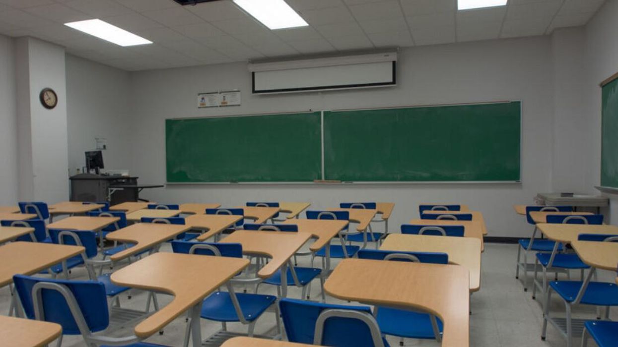 Rows of desks in an empty classroom.