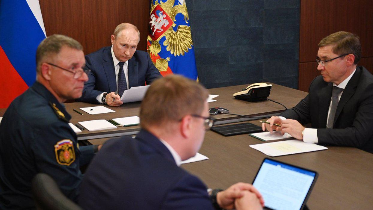 Russian President Vladimir Putin meets with officials back in August.