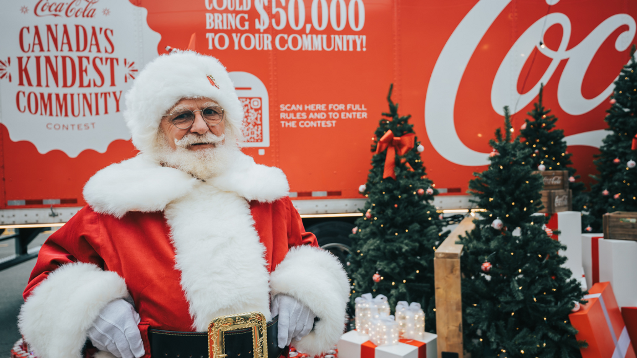 Santa in front of the Coca-Cola Holiday Caravan