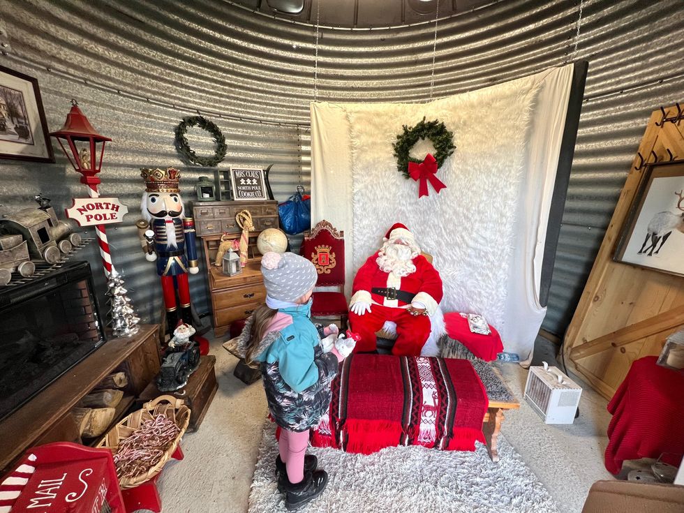 Santa sitting in his workshop.