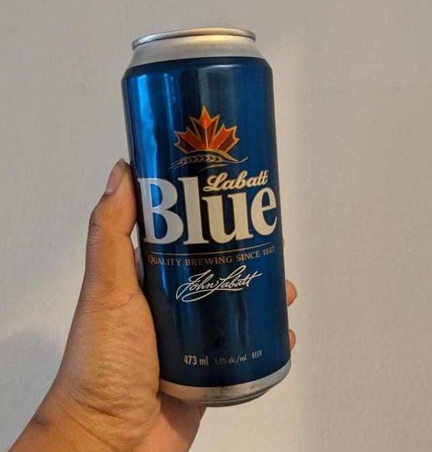 Sarah holding a can of Labatt Blue from the LCBO.