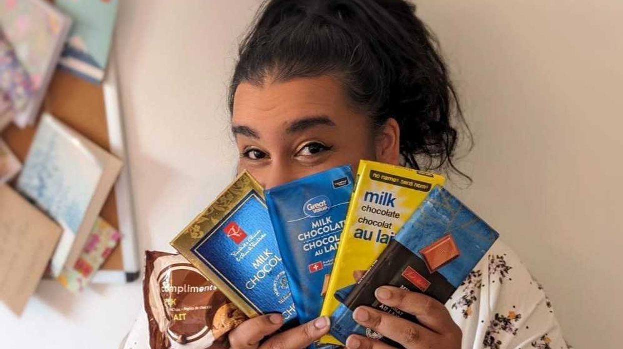 Sarah holding a variety of store brand chocolates.