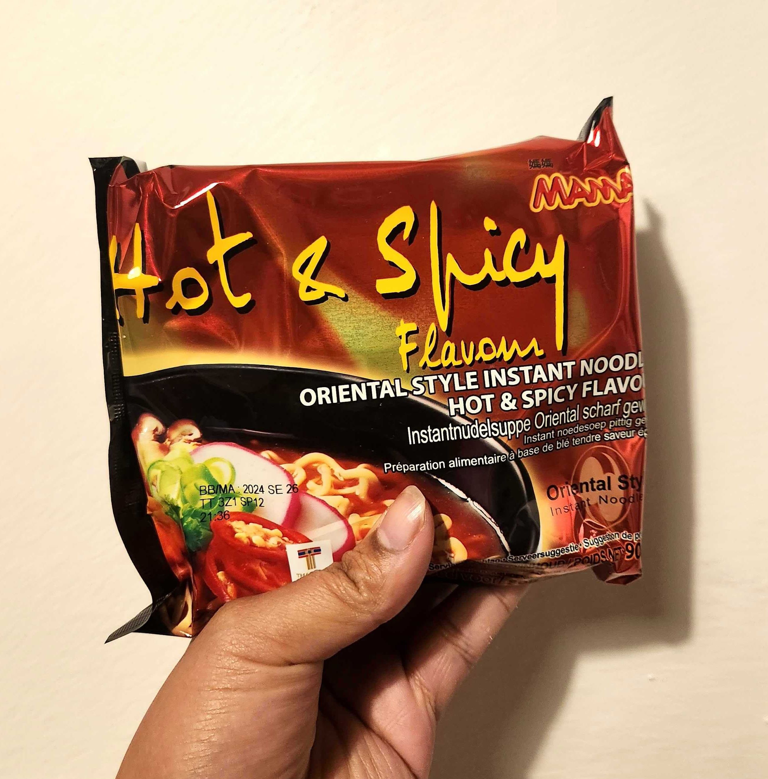 Sarah holding Mama Hot & Spicy Flavour Oriental Style Instant Noodle.