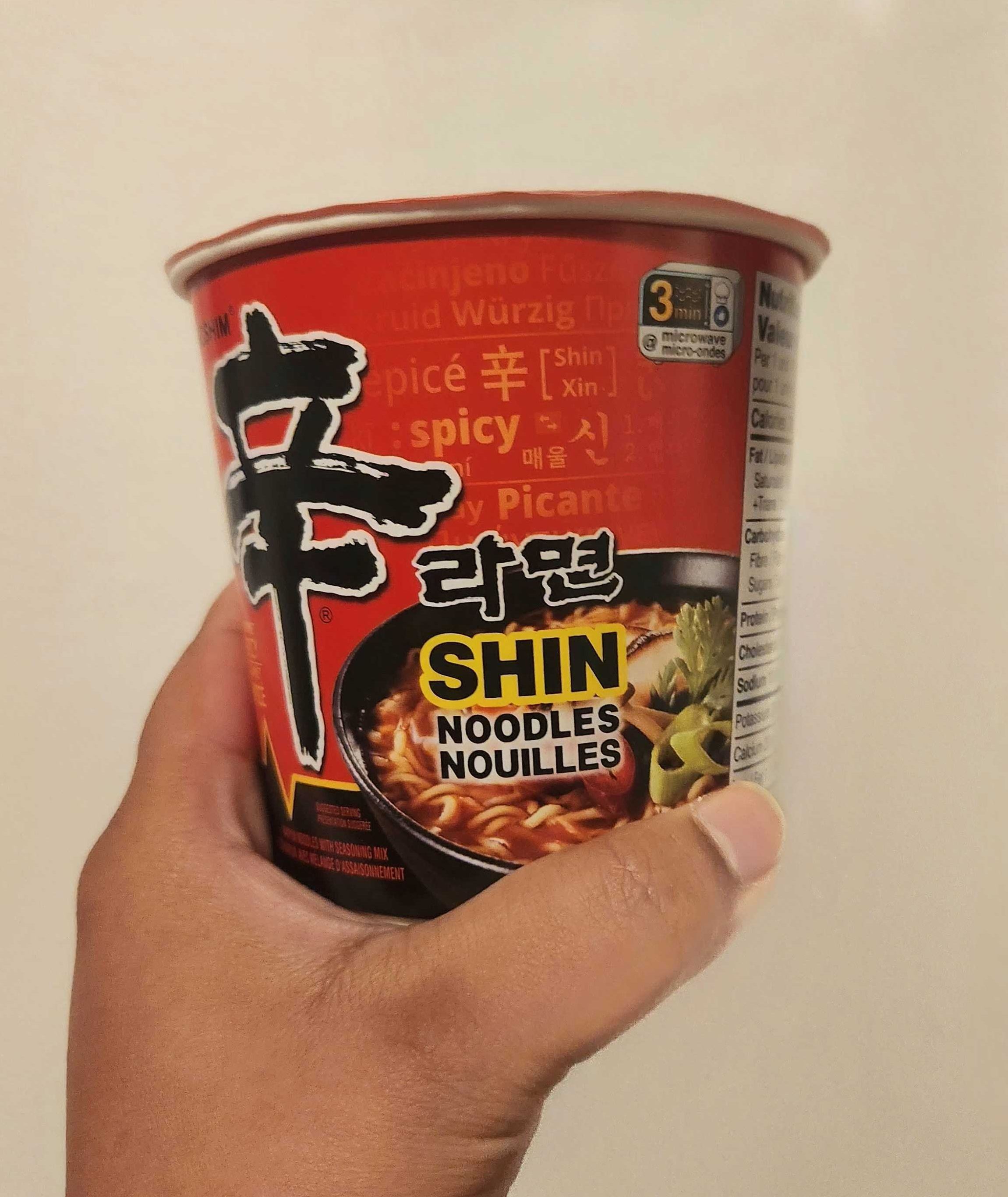 Sarah holding Nongshim Shin Cup.