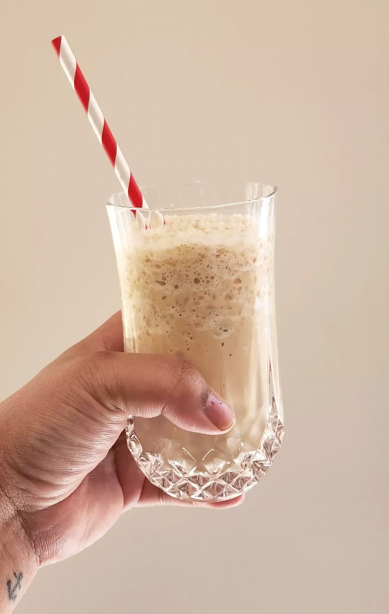 Sarah Rohoman holding a glass of homemade iced capp.