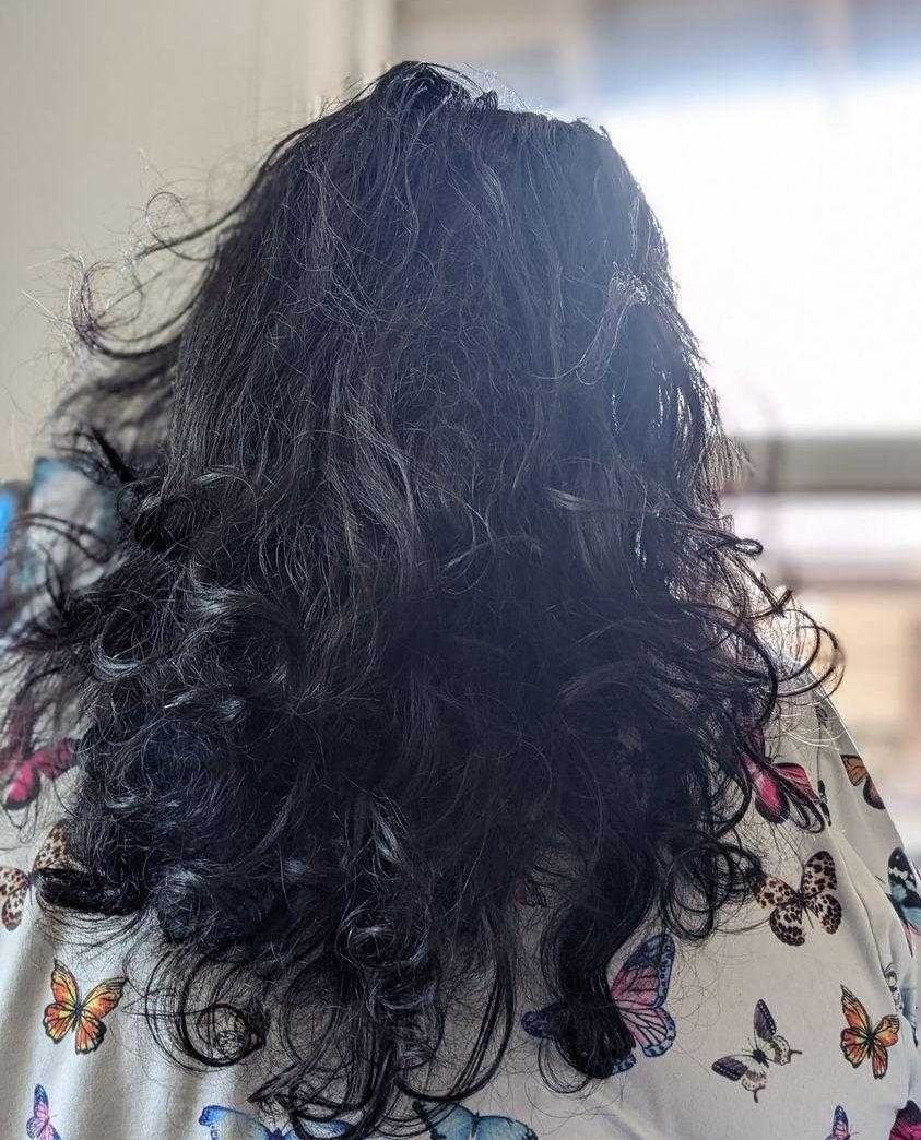 Sarah Rohoman's curly hair before using Sally Beauty products.