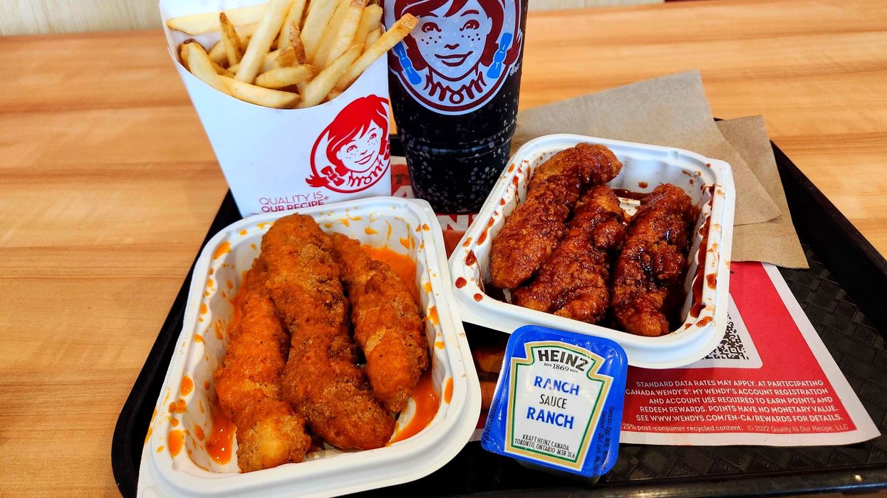 Saucy Chicken Strips from Wendy's on a tray with a drink, fries and ranch sauce.