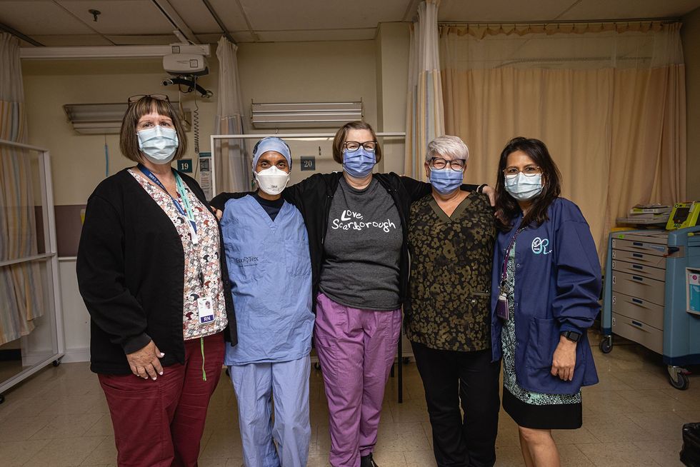 Scarborough Health Network staff stand together for a photo, the person in the middle is wearing a 'Love, Scarborough' t-shirt.