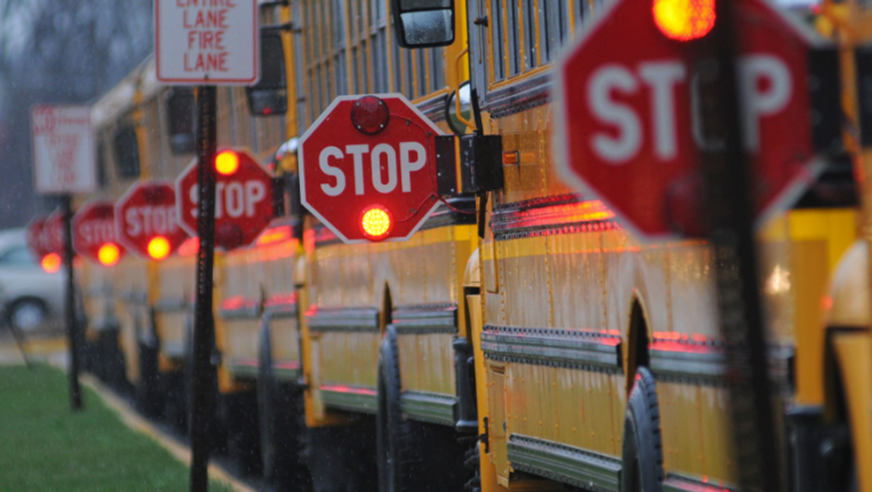 School buses in Ontario with their stop signs pulled out.