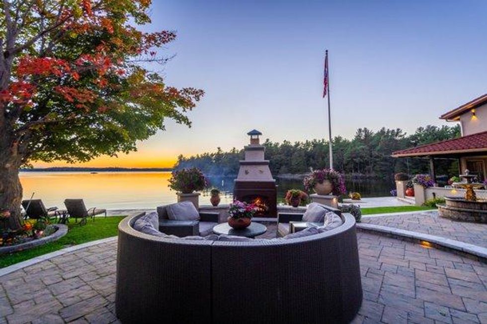 Seating area overlooking the lake with a fireplace.
