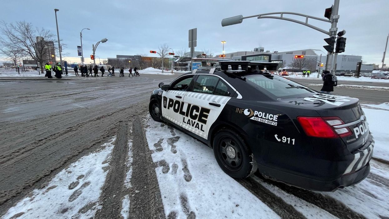 Service de police de Laval car on a street.