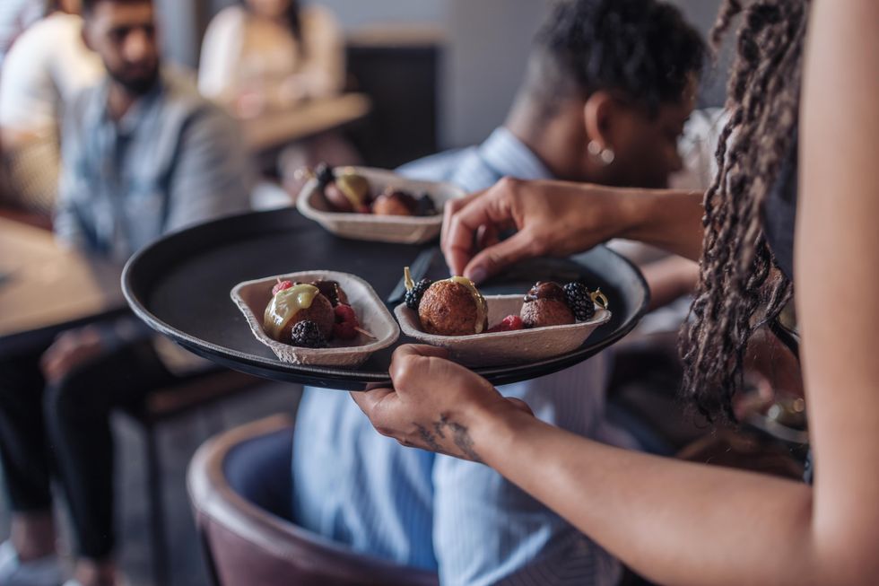 Serving plantain donuts at new Haitian restaurant in Ottawa, Ontario.