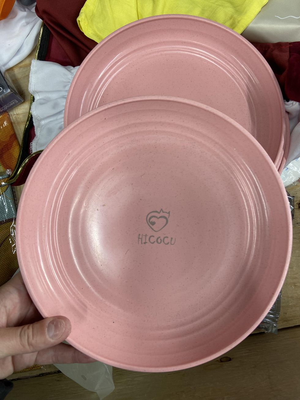Set of four pink plastic plates.