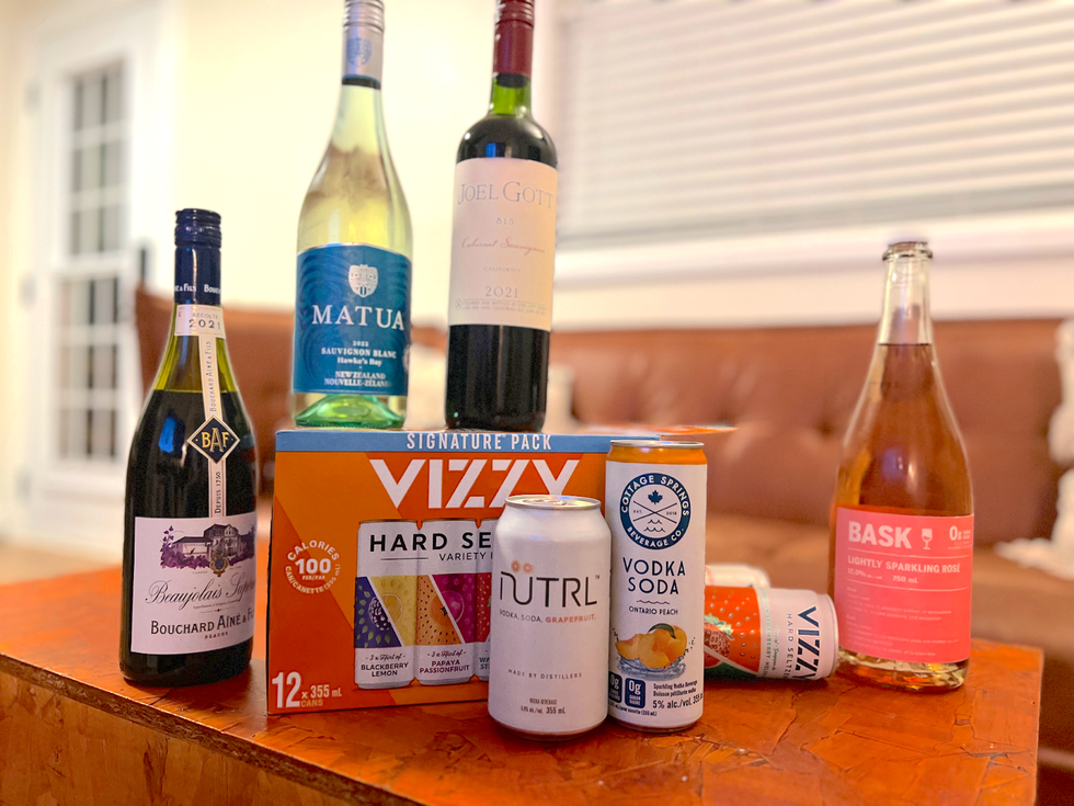 Seven low-sugar wines and coolers from LCBO arranged on a coffee table.