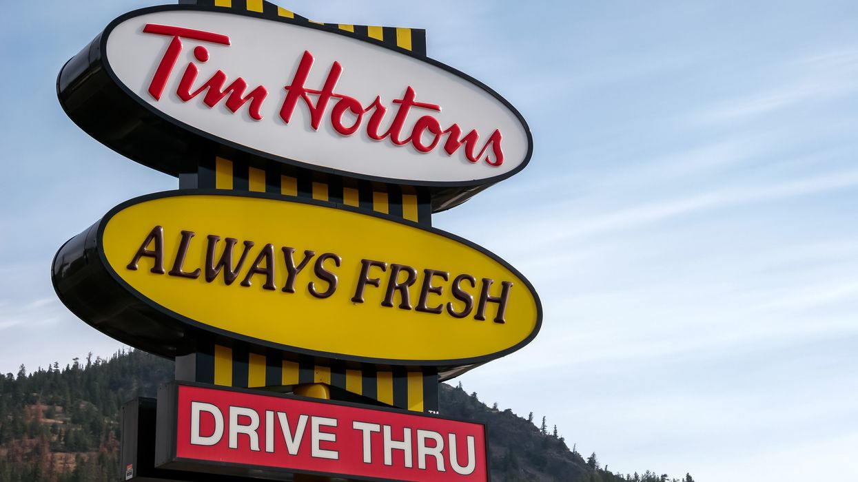 sign at a tim hortons with a drive thru in bc