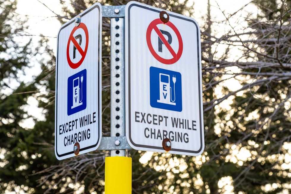 Signs showing no parking at a public electric-vehicle charging area.