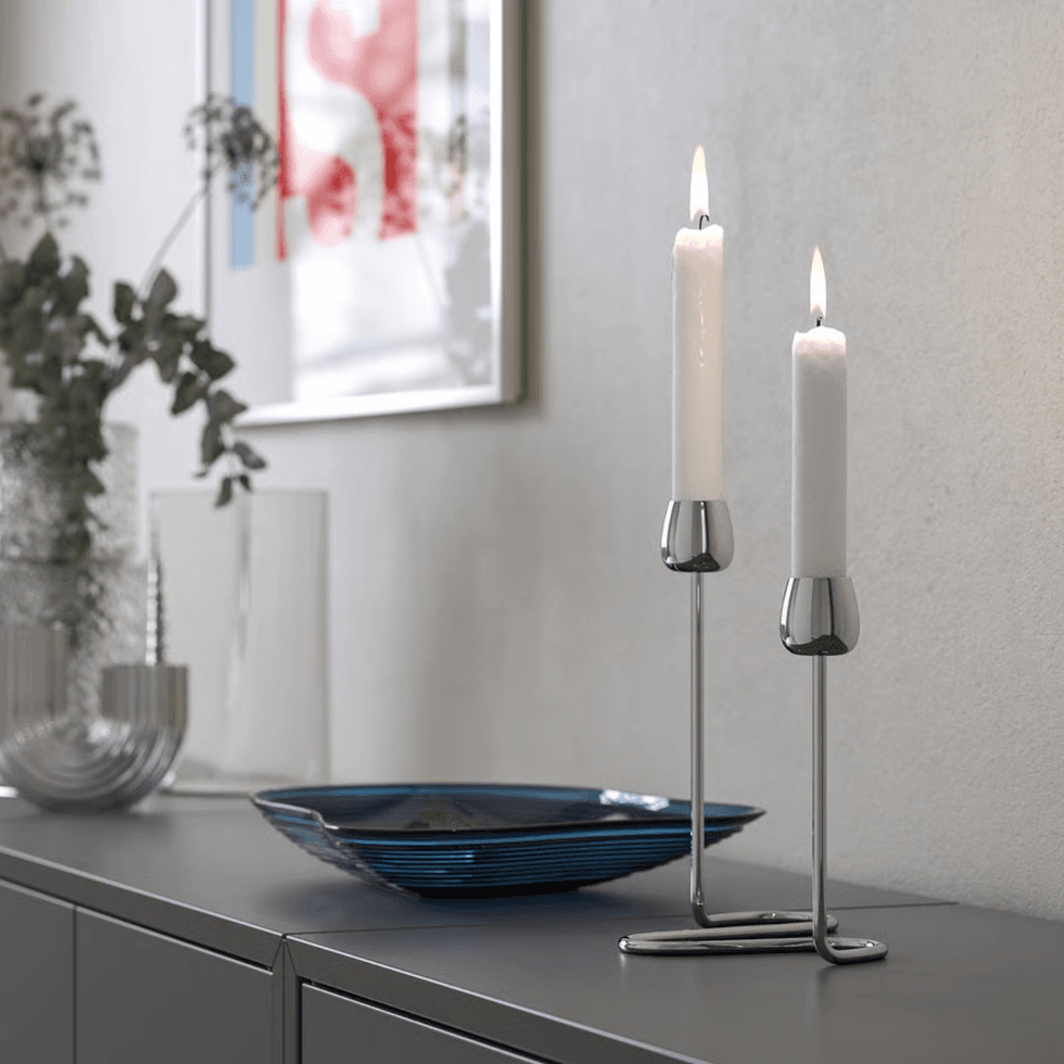 SILVERP\u00c4RON candlestick positioned on a grey sideboard.