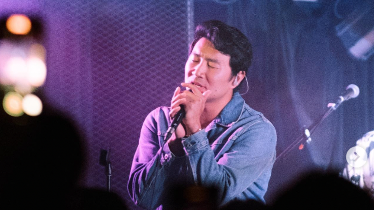 Simu Liu singing on stage.