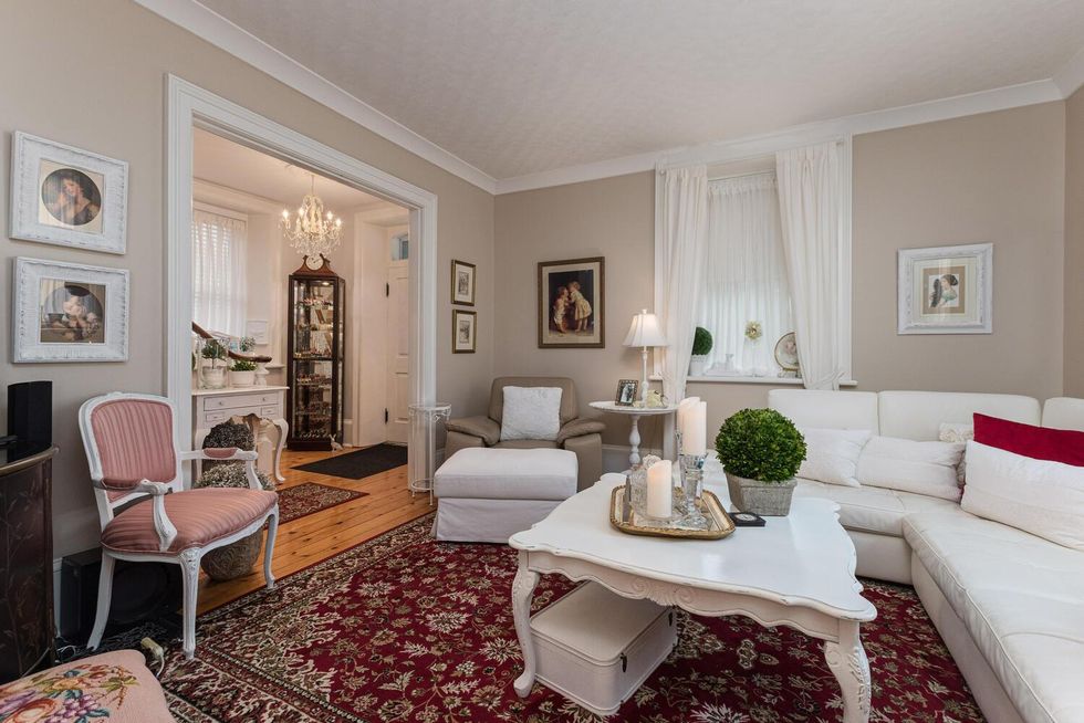 Sitting area with a white couch and white table.