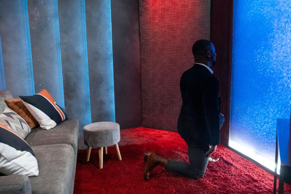 SK Alagbada is down on one knee during his proposal to Raven Ross in a Love Is Blind episode.