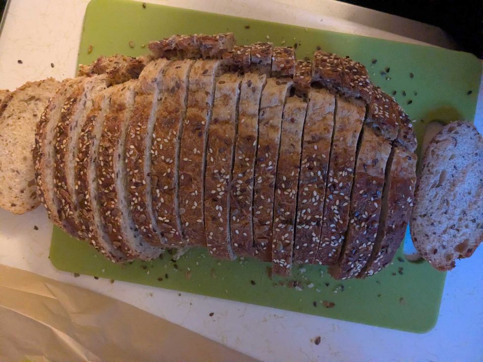 Sliced wholegrain sandwich bread on a cutting board