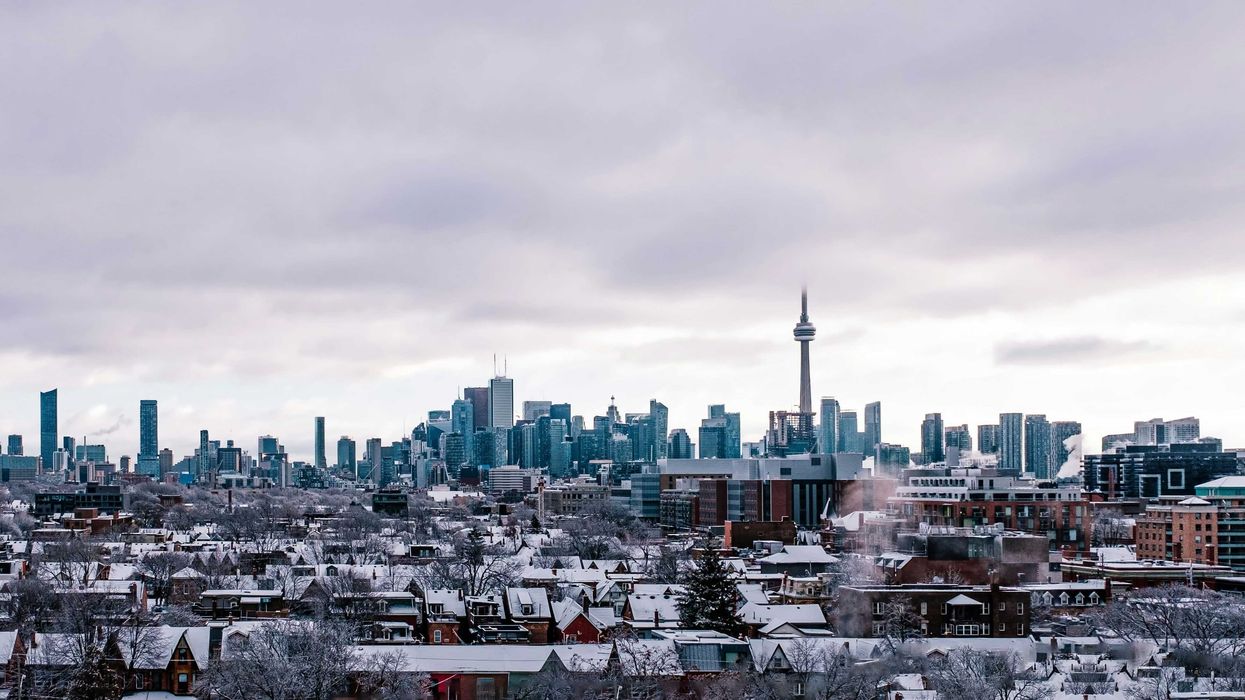 snow covered buildings in the toronto skyline on a cloudy day