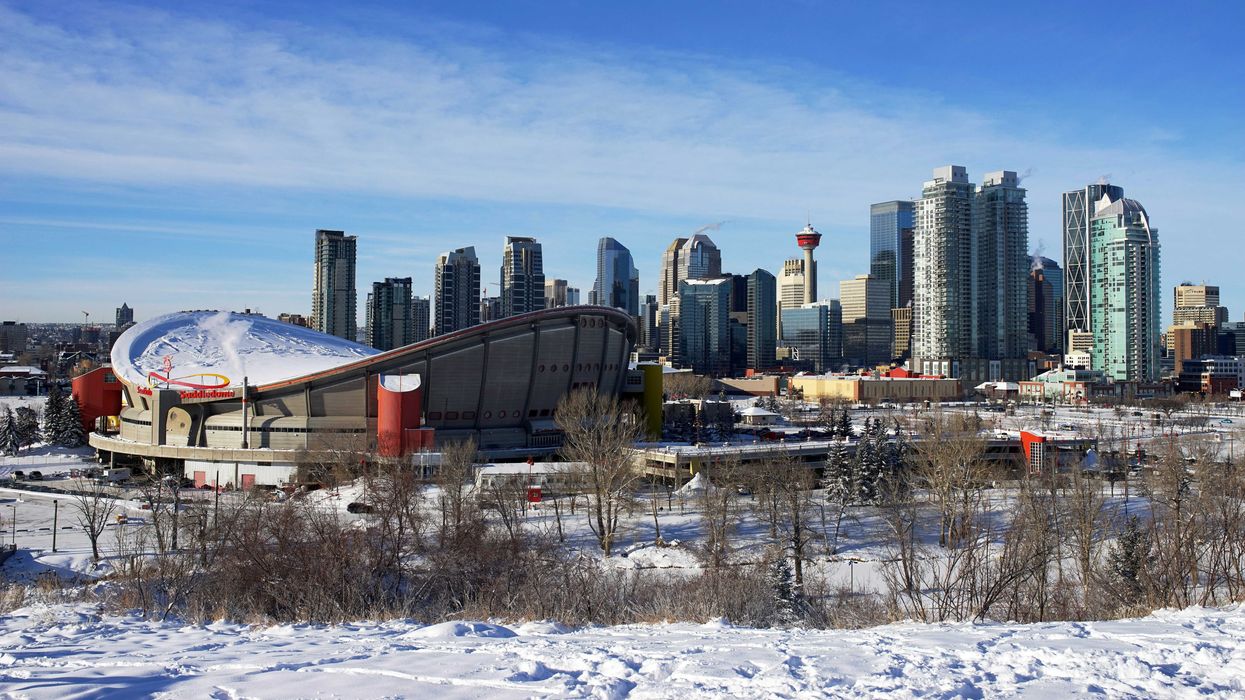 snow covered ground with calgary skyline in the background