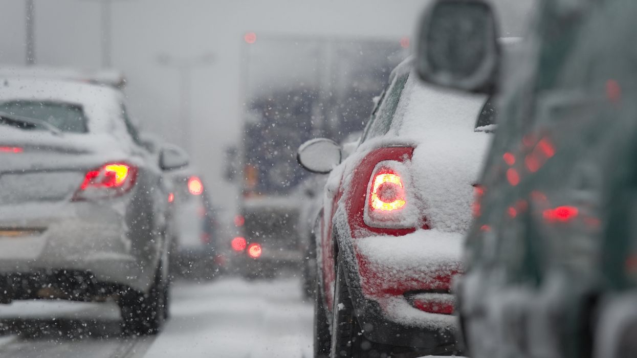Snow on cars that are driving.