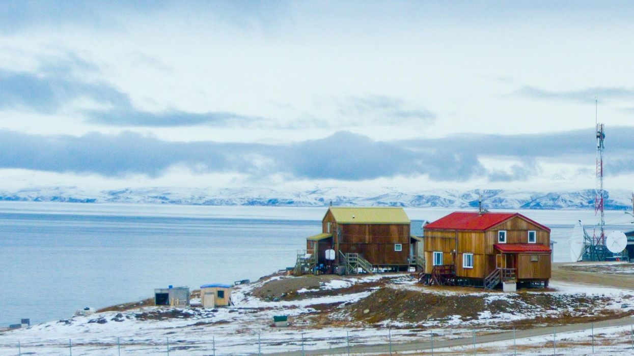 Snow on the ground around houses in Pond Inlet, Nunavut.
