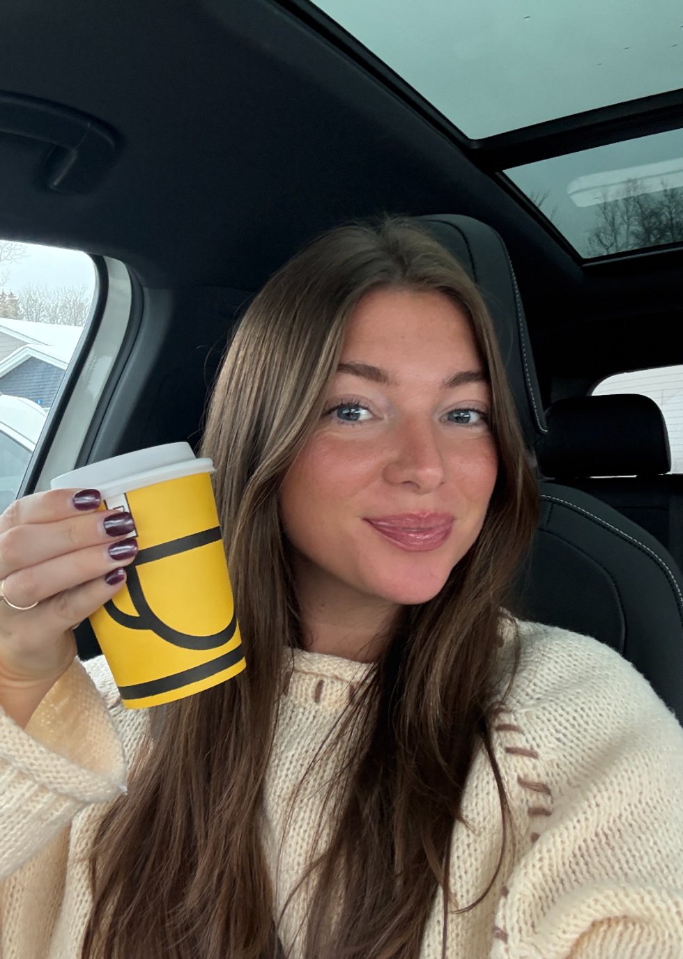 Someone drinking a Second Cup coffee.