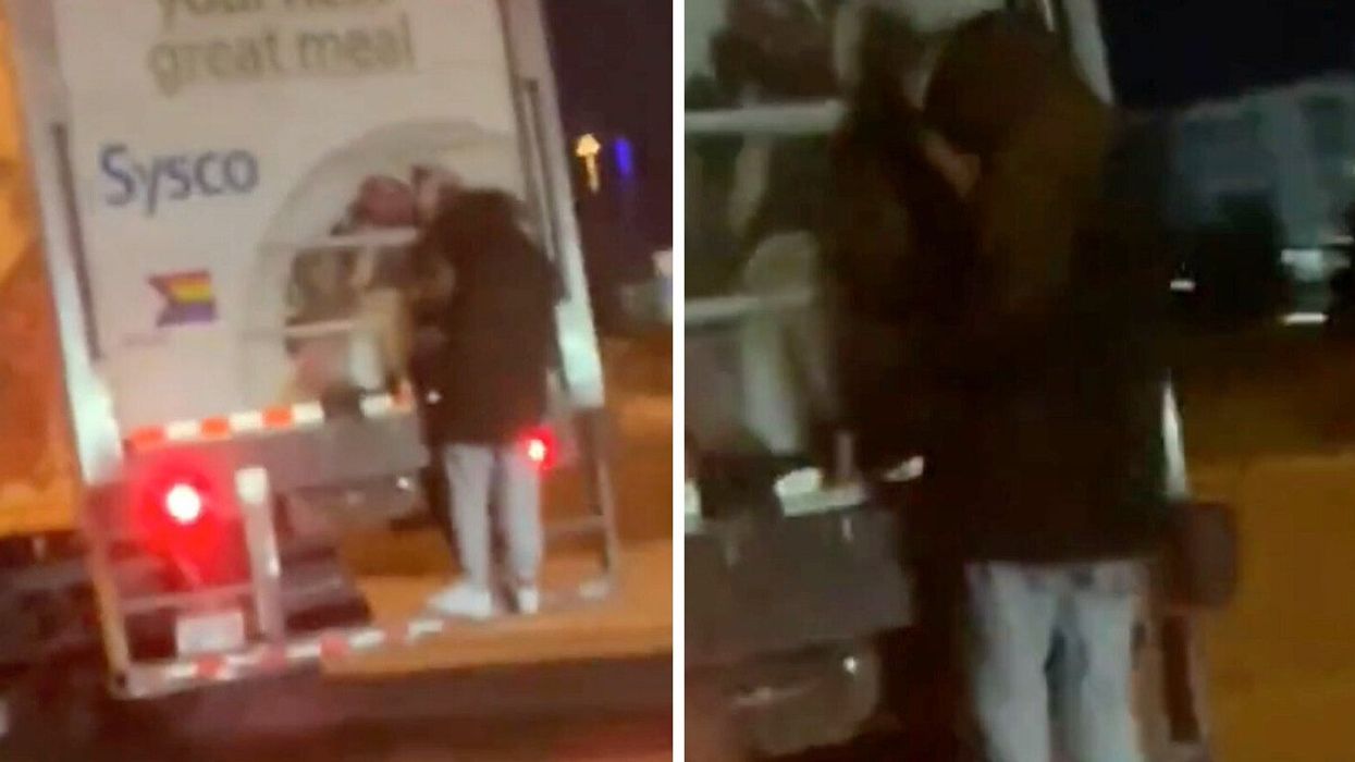 Someone hanging on to the back of a transport truck on the QEW.