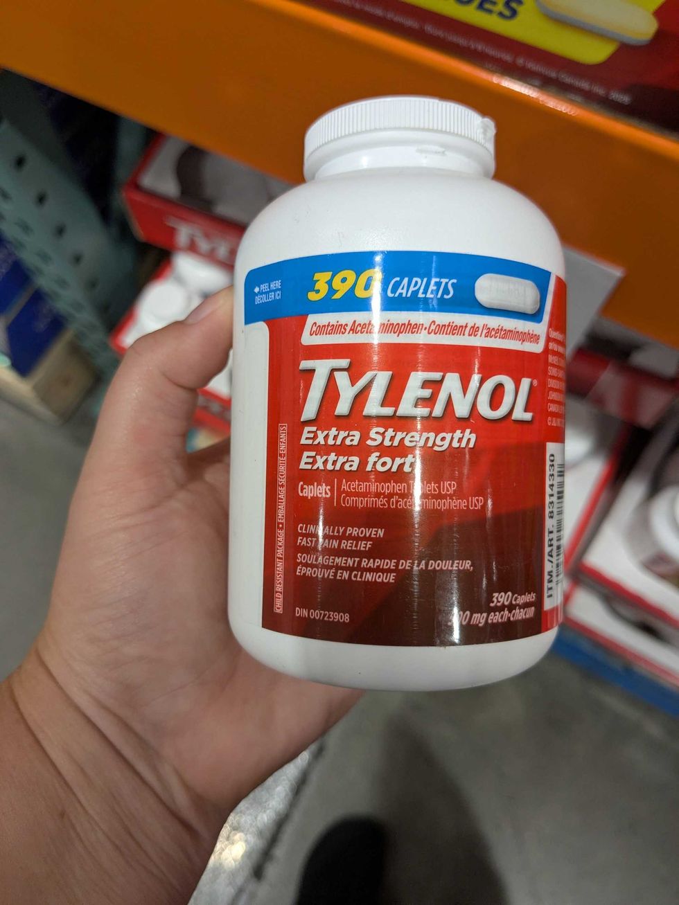 Someone holding a bottle of Tylenol