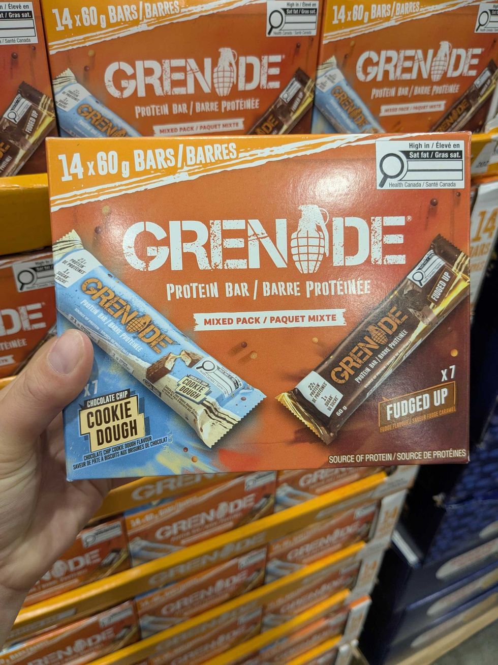 Someone holding a box of grenade protein bars