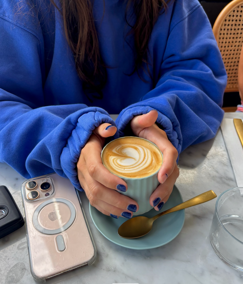 Someone holding a cup of coffee.