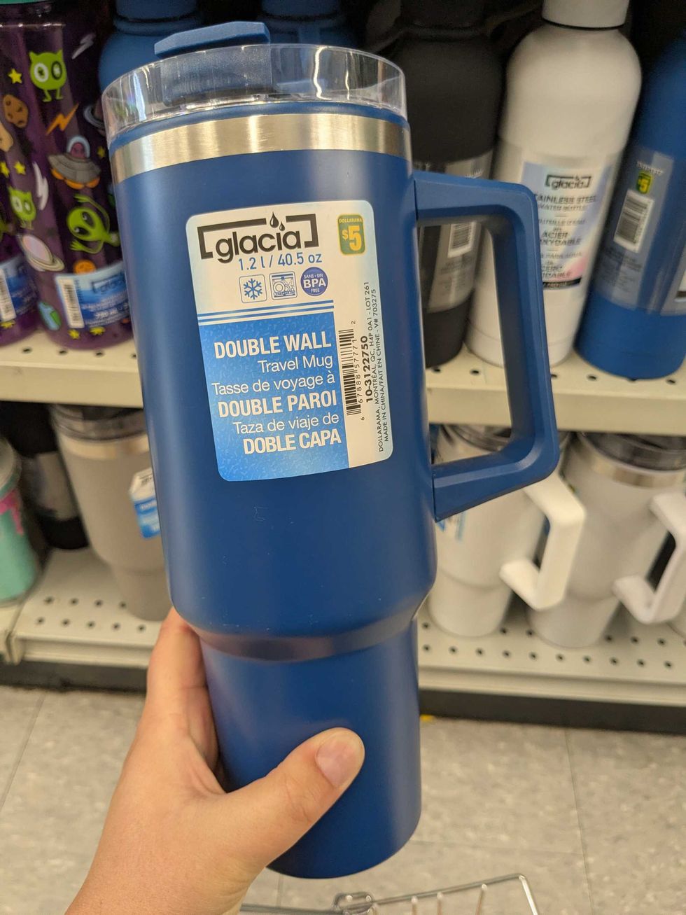 Someone holding a large water bottle from Dollarama