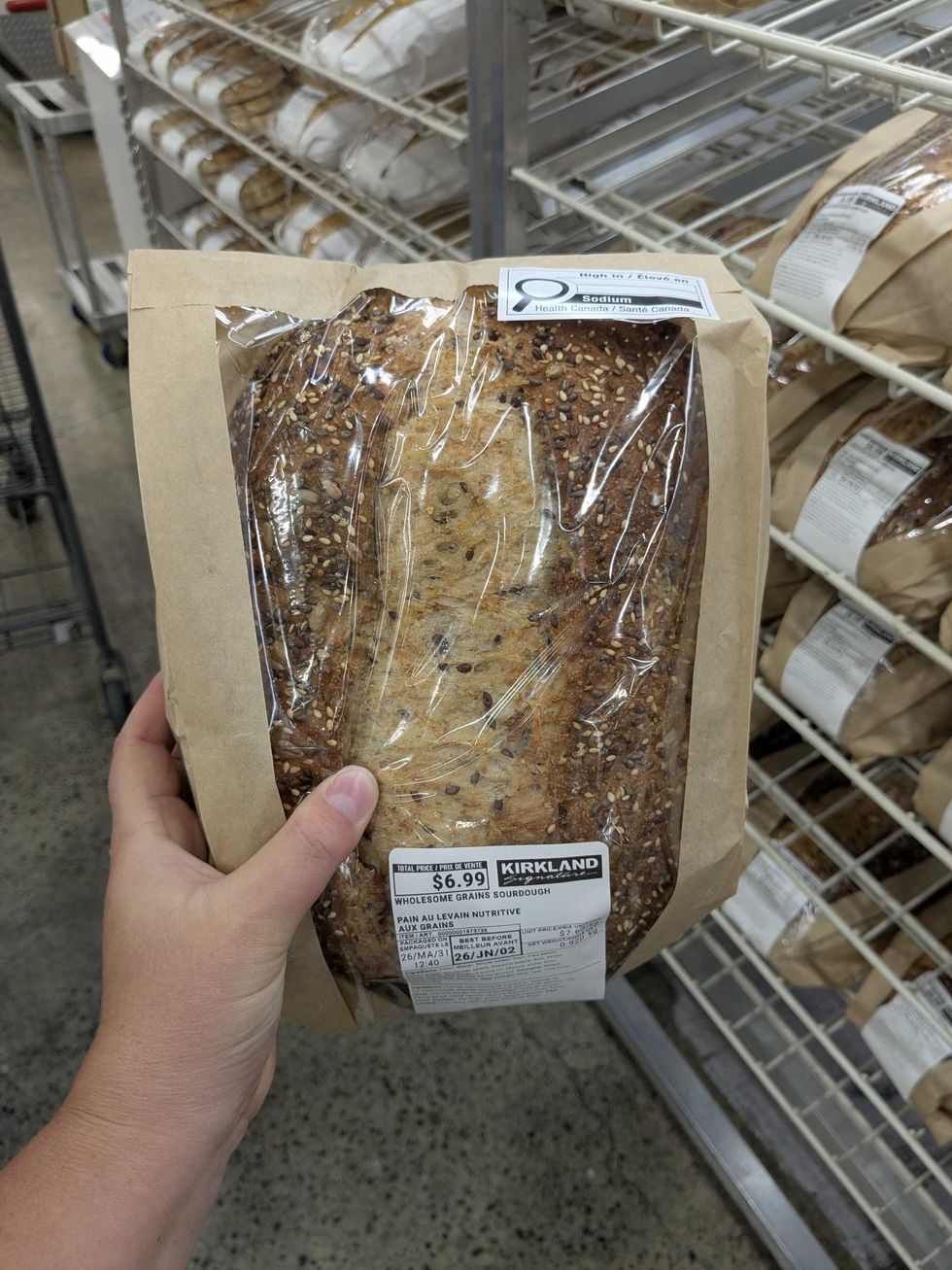 Someone holding a loaf of Costco sourdough bread