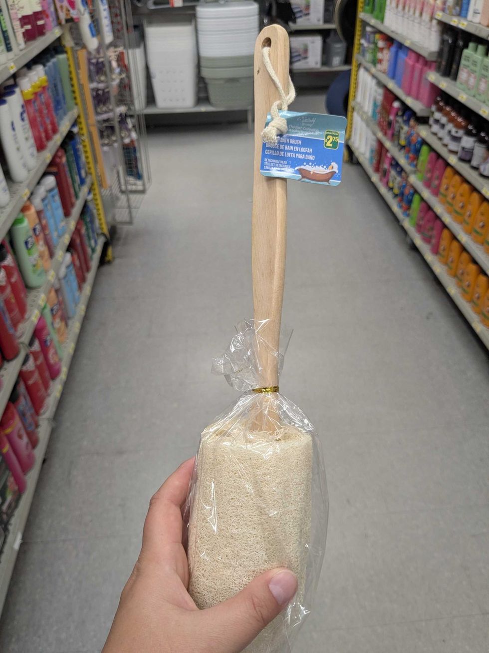 Someone holding a loofah at Dollarama
