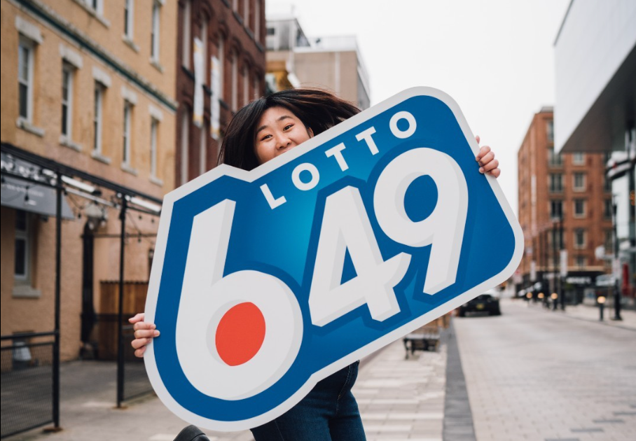 Someone holding a Lotto 6/49 sign.