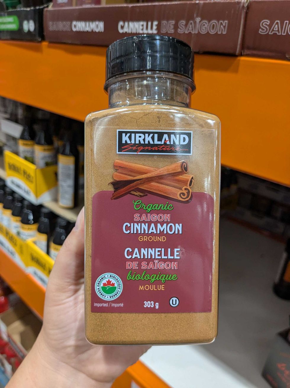 Someone holding a package of Costco Kirkland cinnamon