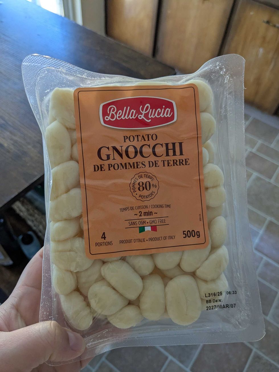 Someone holding a package of gnocchi