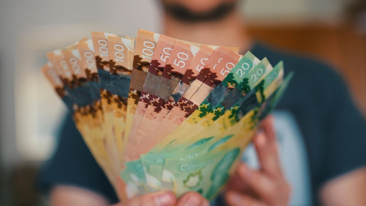 Someone holding Canadian money.