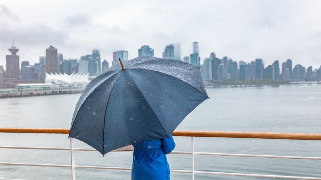 Someone in a city with an umbrella.